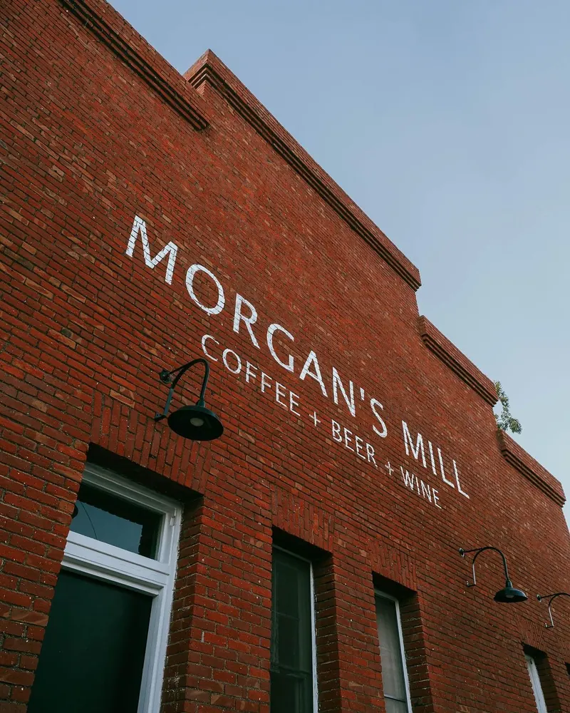 Morgan's Mill coffee, beer, and wine painted on the brick facade of a storefront