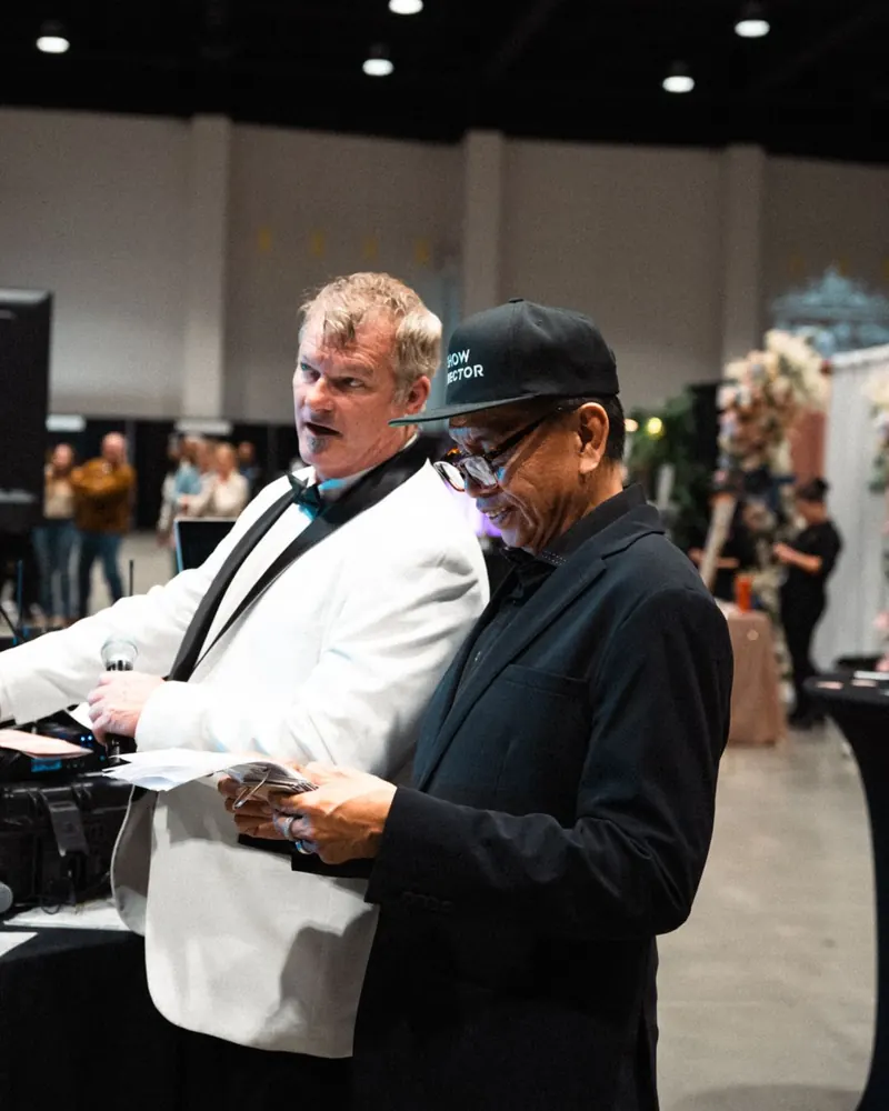 Caterers in white jackets reviewing notes at a Wedding Showcase food station